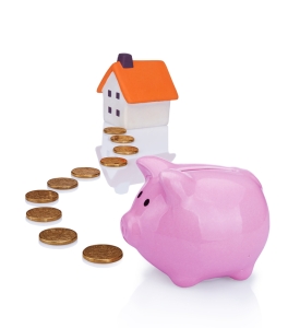 conceptual image with piggy bank, coin and house